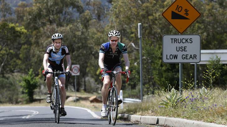 David Osmond and Adrian Sheppard pushing up the slope of Mt Ainslie on Saturday. The pair was riding the climb 43 times to achieve the equivalent of a ride up Mt Everest. Photo: Jeffrey Chan