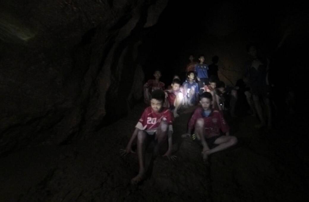 The first sighting of the 12 soccer players trapped in Thailand's Tham Luang cave complex. Photo: AAP