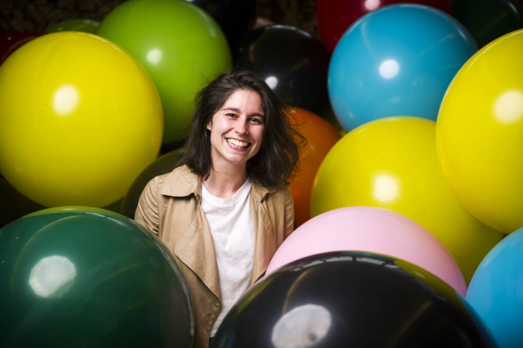 Artist Anne Ouellette from Daily tous les jours lays within the balloon installation that will fill up City Hill tomorrow morning. Photo: Dion Georgopoulo
