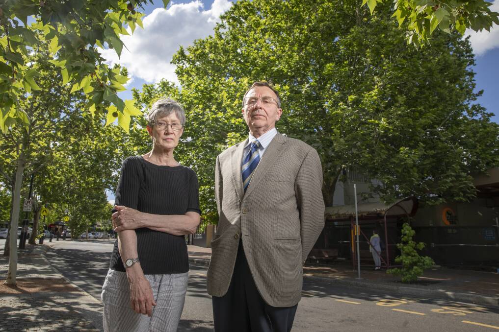 Griffith Narrabundah Community Association member Anne Forrest and president Leo Dobes stand in front of a large protected tree in Griffith that developers are trying to have deregistered.  Photo: Sitthixay Ditthavong