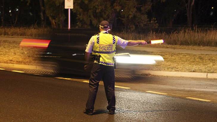 Directing traffic into a random breath test station. Photo: ACT Policing