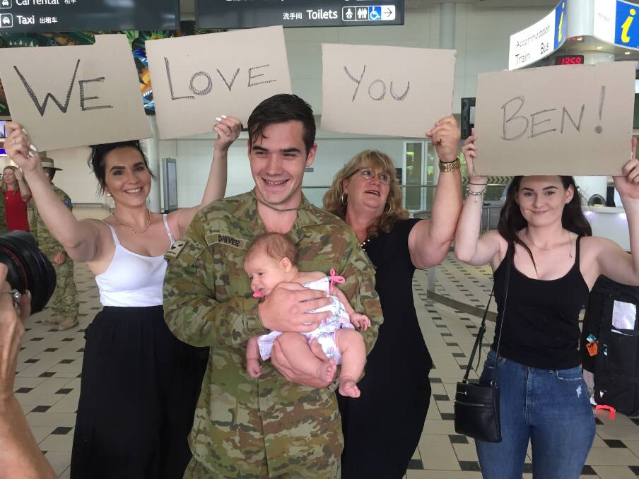 Jenna, Ruby, Janell and Emily were waiting for Private Benjamin Driver at Brisbane Airport on Thursday afternoon.  Photo: Lydia Lynch