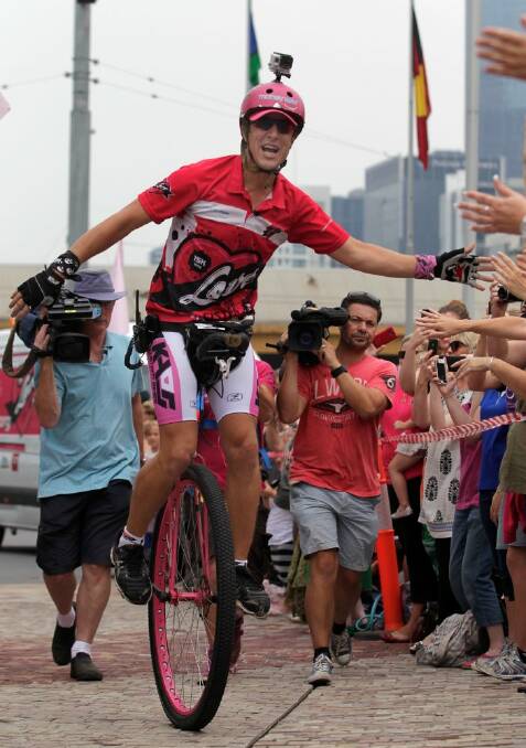 Actor Samuel Johnson finishes his year-long Love Your Sister unicycle trek at the Federation Square to raise money for breast cancer research.  Photo: Eddie JIm