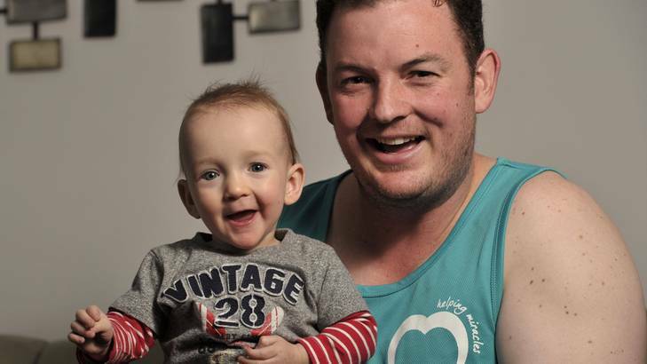 Dave Arnold, of Fadden,  with son Cooper, 11 months. Dave will run in Sydney's City2Surf. Photo: Jay Cronan