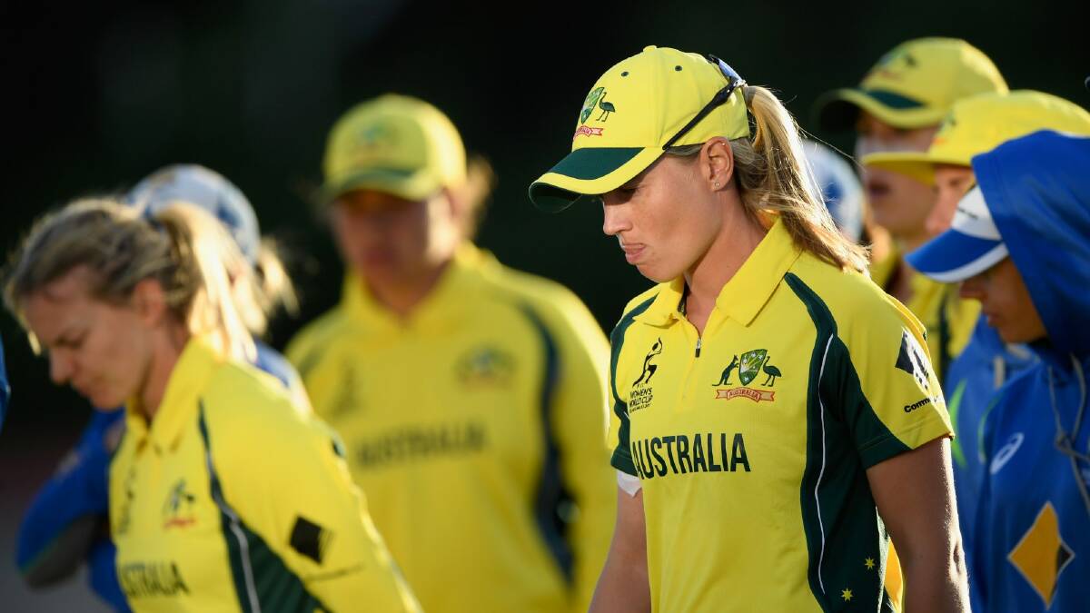Down and out: Australia captain Meg Lanning (right) and her team come to terms with defeat in the World Cup semi-final. Photo: Getty Images