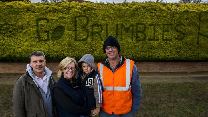 Family of Peter Pearson, Symon Hoy, Philippa Hoy, Sam Hoy (5), and Matthew Pearson have continued his tradition of supporting the Brumbies using the hedge after he passed away last week. Photo: Rohan Thomson