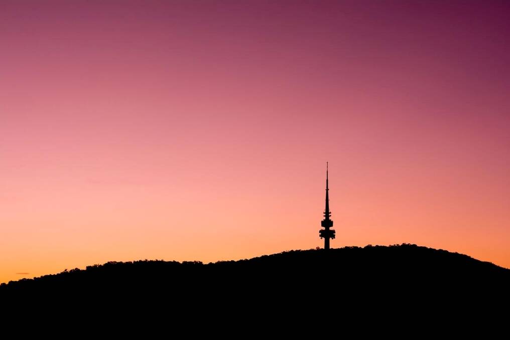 A image of a fiery sky as the sun sets over the Telstra Tower. Photo: Bremer Sharp