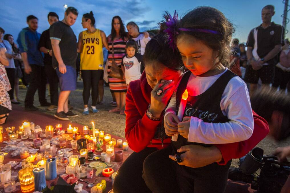 Mourners held a vigil outside Dreamworld after the tragedy. Photo: Glenn Hunt