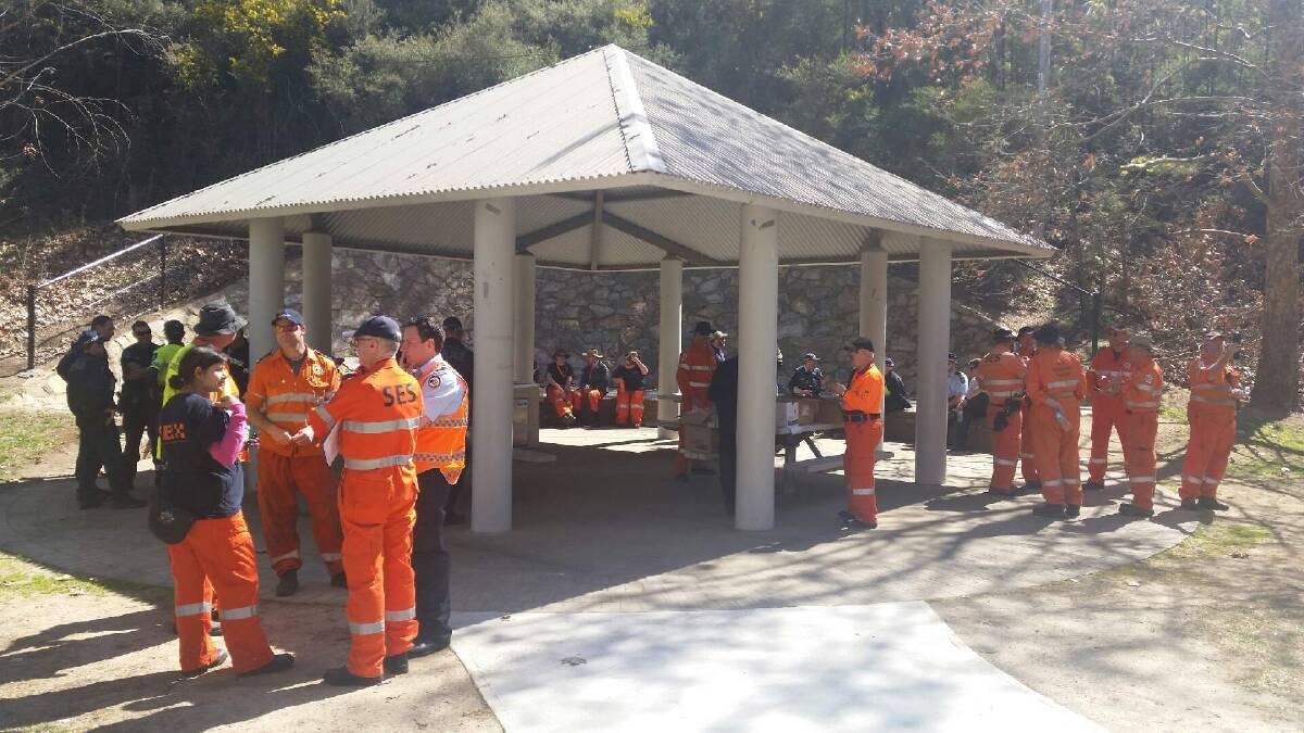 Police and the SES debrief at cotter reserve after finding missing Canberra woman Kathleen Bautista. Photo: Megan Gorrey