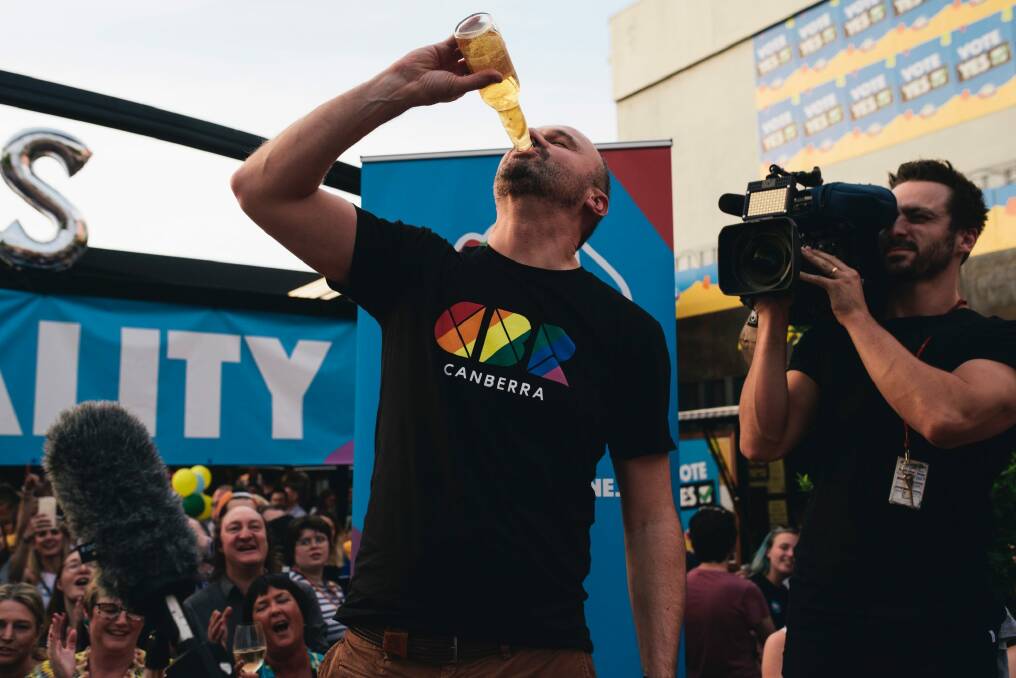 More elegant than Bob Hawke and his schooners. ACT Chief Minister Andrew Barr celebrated Australian voting yes for marriage equality by downing a Corona. And, yes, there was a slice of lemon in there. Photo: Rohan Thomson