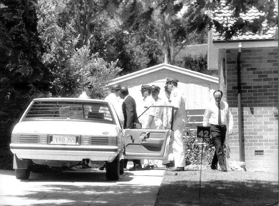 Detective Sergeant Bob Lehman and police with the car in which Assistant Commissioner Colin Winchester was shot in his neighbour's driveway in 1989. Photo: Jon Beale