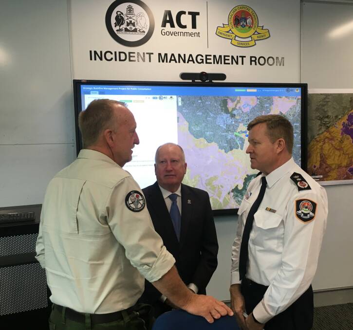 ACT Parks fire manager Neil Cooper, Emergency Services Minister Mick Gentleman, and ESA Commissioner Dominic Lane discuss the bushfire risk. Photo: Peter Brewer.