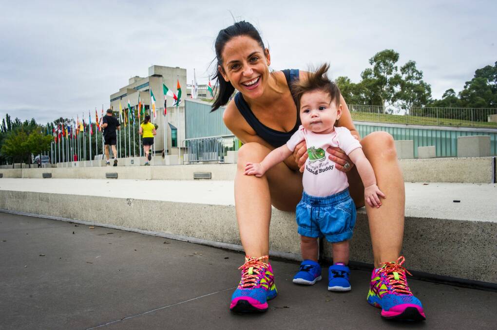 Former Canberran Kristine Elliot will run the 10km in the Australian Running Festival and try to beat her pre-baby time. Pictured with 6mth old daughter Olive.  Photo: Elesa Kurtz