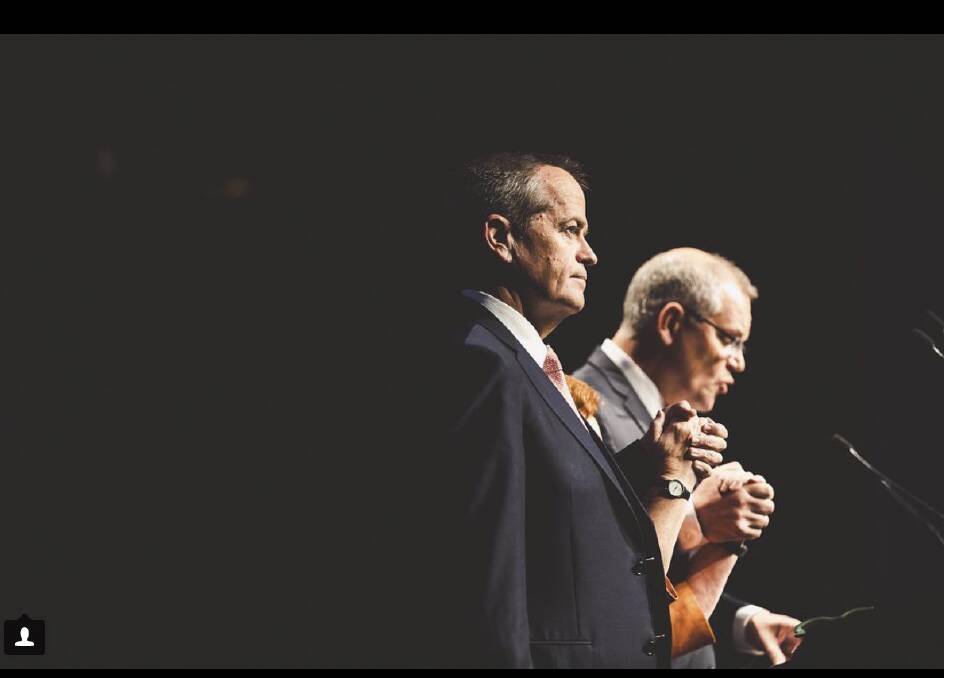 Opposition Leader Bill Shorten, and the Prime Minister of Australia Scott Morrison hold hands during the National Apology to Victims and Survivors of Institutional Child Sex Abuse. Photo: Jamila Toderas