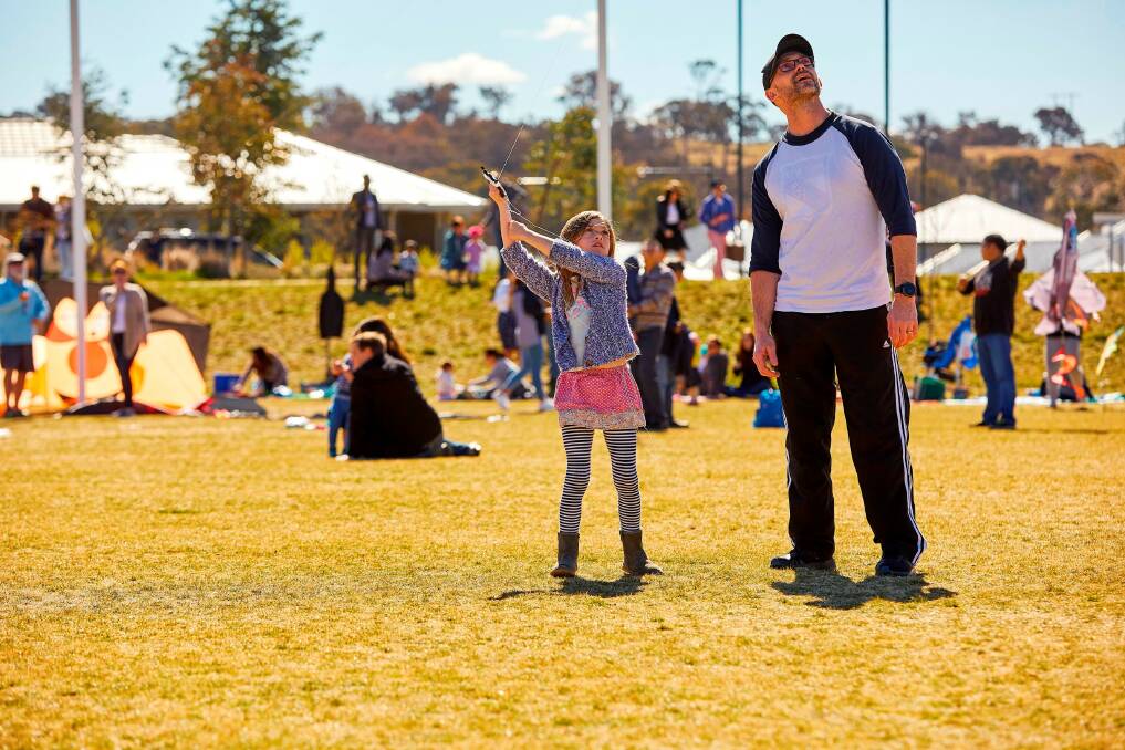 Dan and Poppy Fasch, of Googong, try their hand at kite flying at the Flying High event in Googong. Photo: Supplied