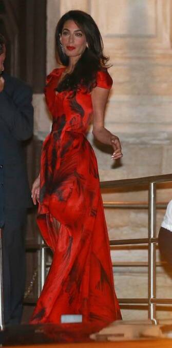 Amal Alamuddin arriving in Venice prior to her wedding to George Clooney wearing an Alexander McQueen gown.