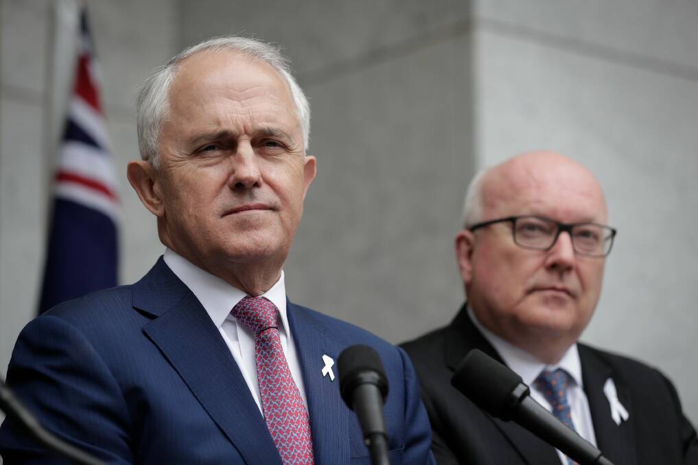 Prime Minister Malcolm Turnbull and then attorney-general George Brandis announced the new espionage laws in December 2017. Photo: Alex Ellinghausen
