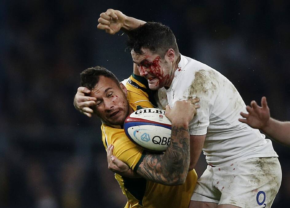 Rugged tour: Quade Cooper is smashed in a tackle by Brad Barritt. Photo: AFP
