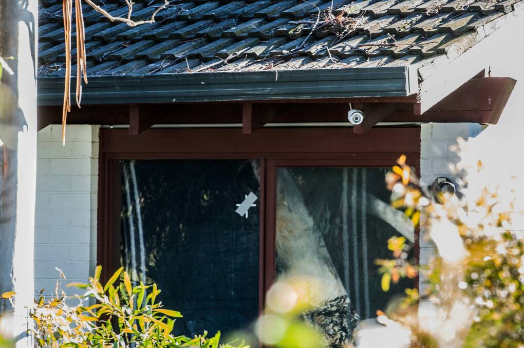 Bullet holes in the window of the Waramanga home targeted in Tuesday night's shooting.  Photo: Karleen Minney
