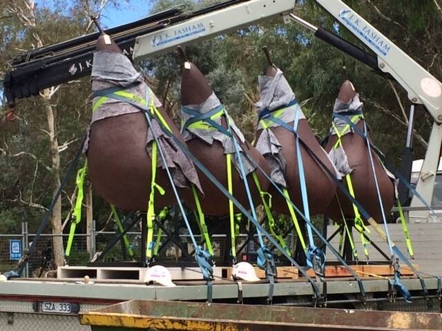 The seven pears of Pear - version number 2 are being moved from their prime location at the front of the National Gallery of Australia in Canberra to make room for a new "gravity-defying'' sculpture being unveiled soon.  Photo: Megan Doherty