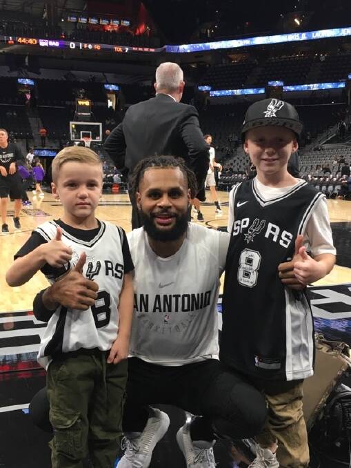 San Antonio Spurs NBA player Patty Mills greeting Luke Allen after winning a competition for his Game Day! book Photo: Supplied