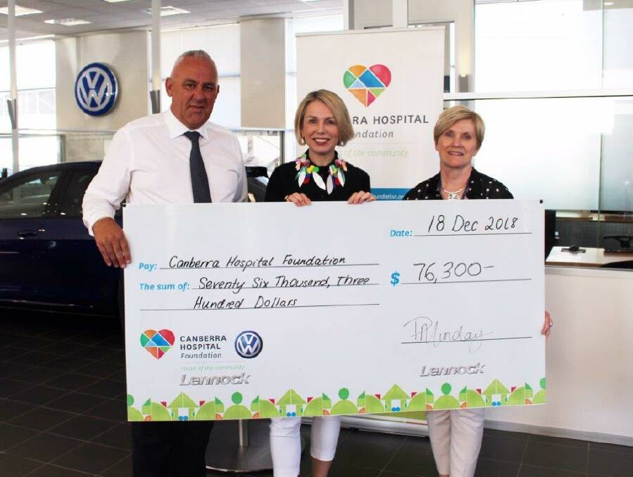 Peter Munday presenting a cheque to the Canberra Hospital Foundation. Photo: Supplied
