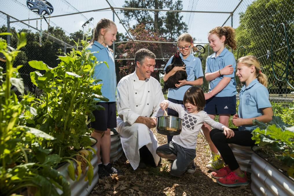 Ainslie Primary students Charlie Robertson (year 1), Indigo Buckman (year 3), Max Piper (pre-school), Holly Bruce (year 4), and Teegen Piper (year 4), with chef Jeff Piper at the school ahead of the release of the Ainslie PS cookbook.   Photo: Rohan Thomson