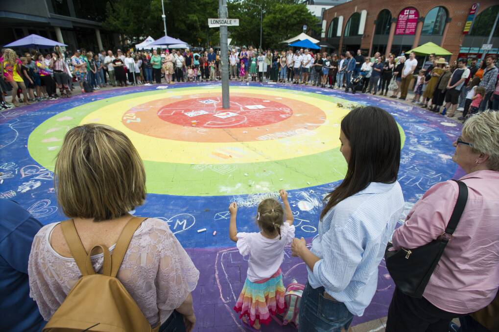 The circle of love at the rainbow roundabout on Lonsdale Street during Saturday's Yes!Fest. Photo: Elesa Kurtz