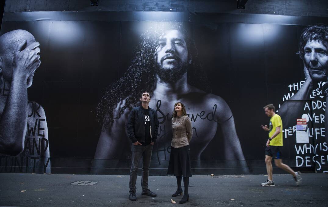 Looking up: Two Good Co director Rob Caslick with Lendlease project director Kimberley Jackson in front of a mural by artist Shannon Crees. Photo: Louise Kennerley