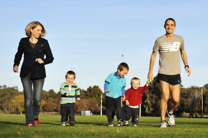 Olympic marathon runner, Martin Dent with his wife Kathie Dent and three boys Elye (blue Shirt), 4, Connor (red shirt), 2, and Hayden (striped shirt), 2 before training at Aranda Oval. Photo: Jay Cronan