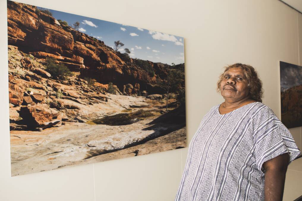 Marita Baker with her photograph Kalaya Tjukurpa, painted at Kanpi Rockhole. Photo: Jamila Toderas