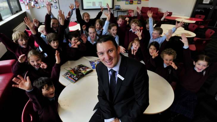 SMILES: David Austin, principal, with students at St Francis of Assisi Primary School. Catholic systemic schools will receive an additional $198 million. Photo: Jay Cronan