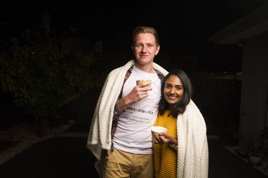 Canberra couple Adam West and Vinu Gamage are offering the perfect winter job. Photo: Dion Georgopoulos