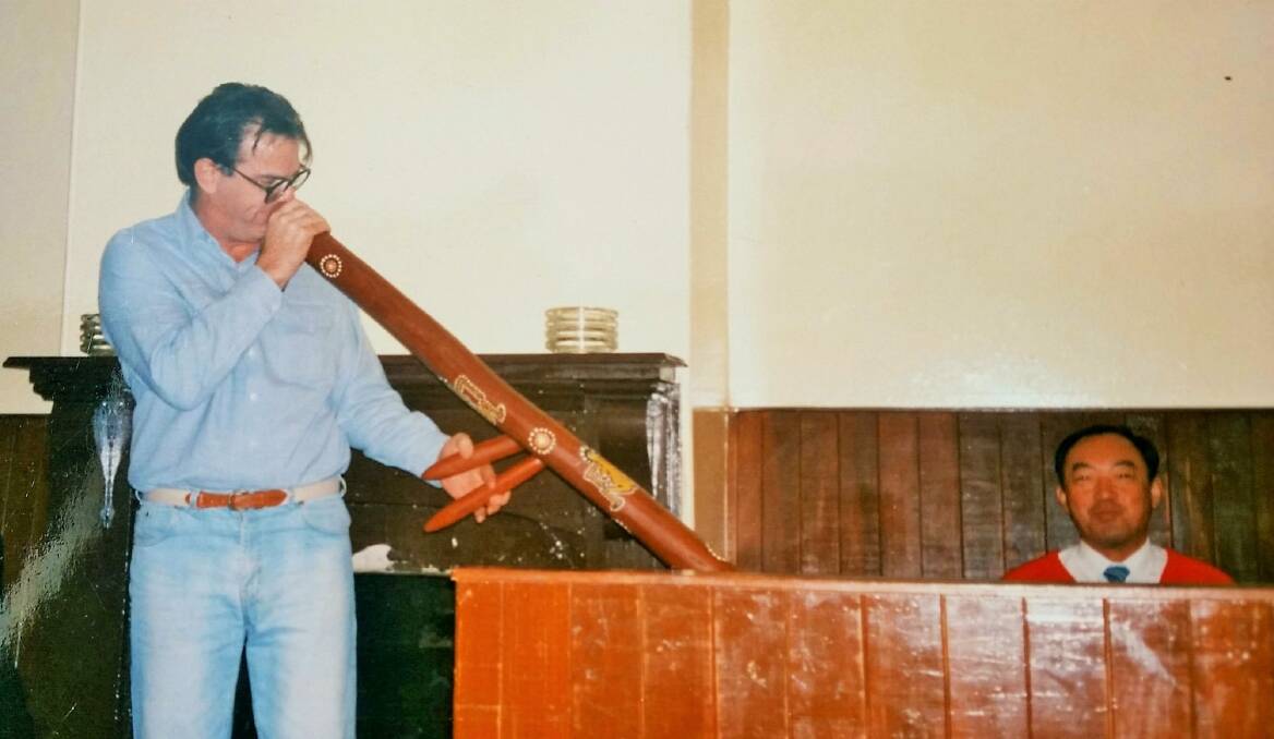 Gundaroo Pub owner Ron Murray entertains Japanese tourists with his didgeridoo in 1980  Photo: Murrays Coaches