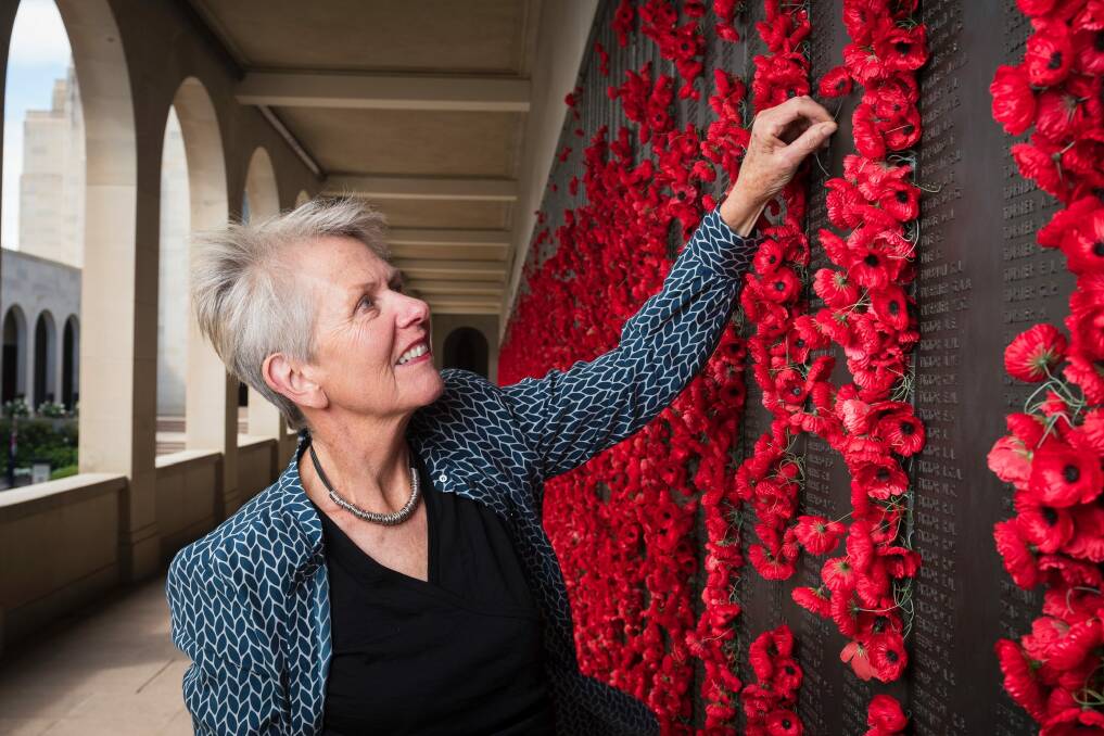 Judith Eisman places a flower at the Australian War Memorial for her uncle Morris Solomon. Photo: Dion Georgopoulos