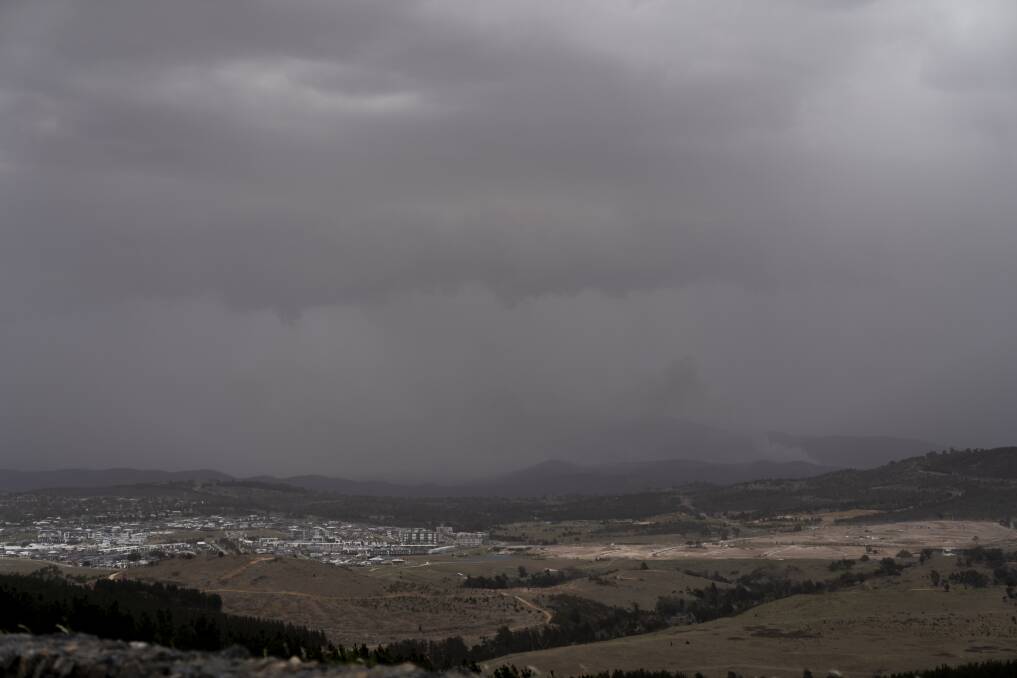 The view from the National Arboretum on Friday afternoon. Canberra battled smoke, strong winds and rain. Photo: Lawrence Atkin