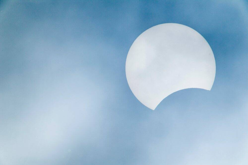 An earlier partial solar eclipse as seen through the clouds over Canberra.  Photo: Rohan Thomson