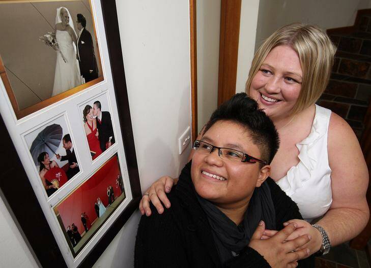 Catalina Parish and Aimee Parish have a look at wedding photos from their Civil Union two years ago. Photo: Jeffrey Chan