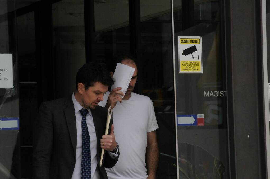 Peter Poulakis, right,  leaves court with his lawyer after he was granted bail. Photo: Alexandra Back