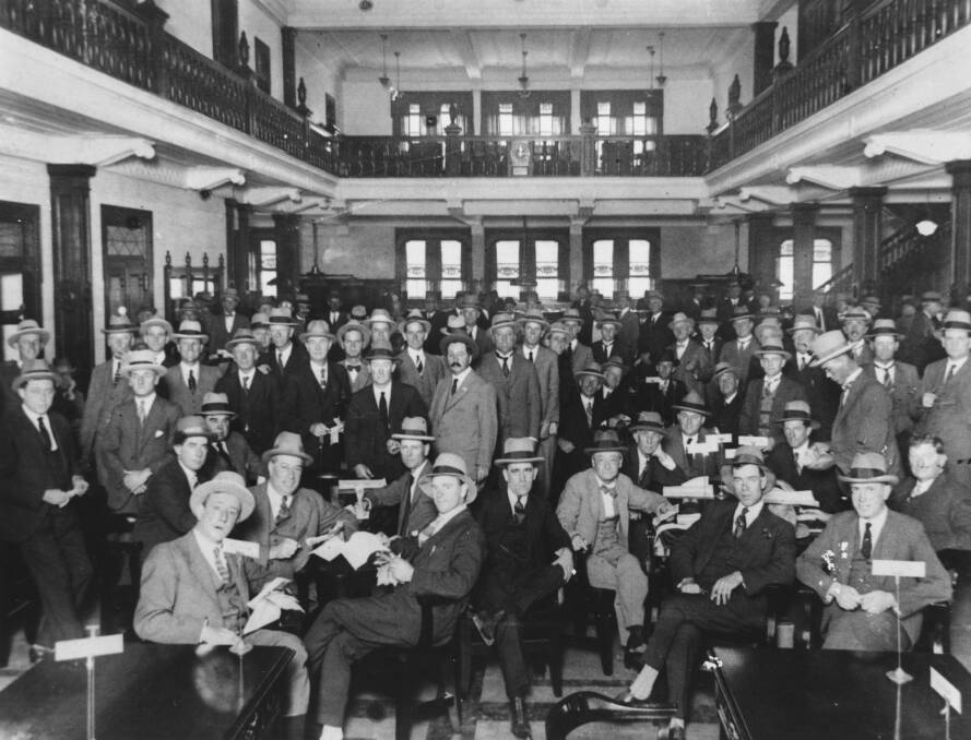A Supreme Court case is challenging the validity of a vote to allow women to become members of the Tattersall's Club. Pictured is settling day at the club for bookmakers and clients in 1926. Photo: State Library of Queensland