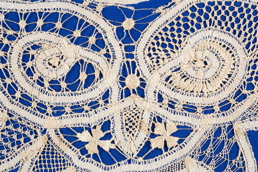 Fine lacework on a blue background. Photo: Embroiderers Guild of Queensland