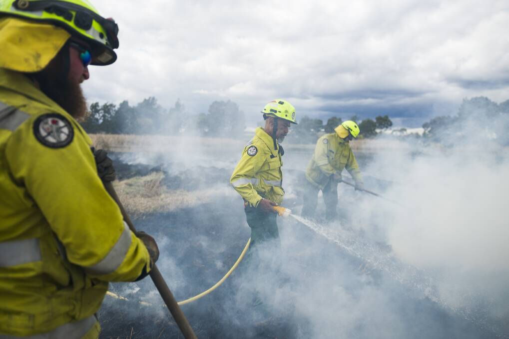 Aboriginal fire project officer Dean Freeman putting out a controlled fire during a cultural and ecological burn at the Jerrabomberra Wetlands.  Photo: Dion Georgopoulos
