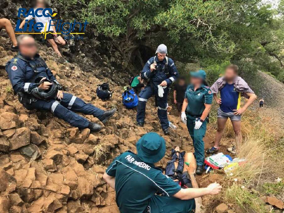 A RACQ LifeFlight Rescue helicopter was called to winch a man from the Table Top Mountain after he fell about 10 metres while hiking with friends on Sunday. Photo: RACQ LifeFlight Rescue
