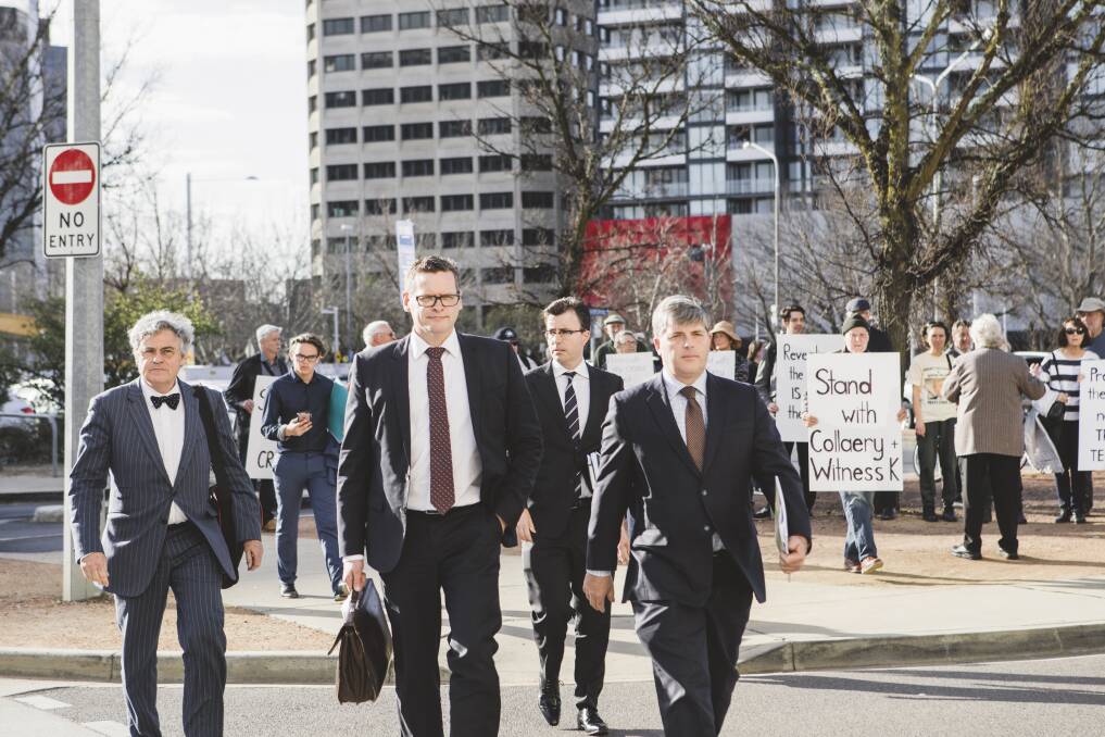 Witness K's lawyer Haydn Carmichael (far left) and Mr Collaery's barrister (far right) pass protesters as they arrive at court on Wednesday. Photo: Jamila Toderas