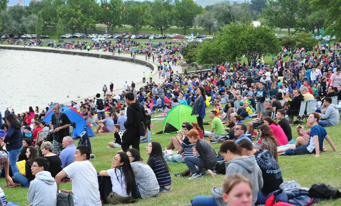 People gather for the Australia Day fireworks on the shores of Lake Burley Griffin. Canberra's population was hovering around 392,000 in the middle of 2015 and will probably reach 400,000 within the next 12 months. Photo: Melissa Adams