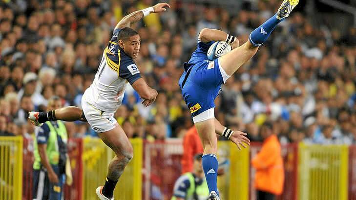 Mid-air struggle ... Joseph Tomane of the Brumbies and Gerhard van de Heever fly for the high ball. Photo: Getty Images
