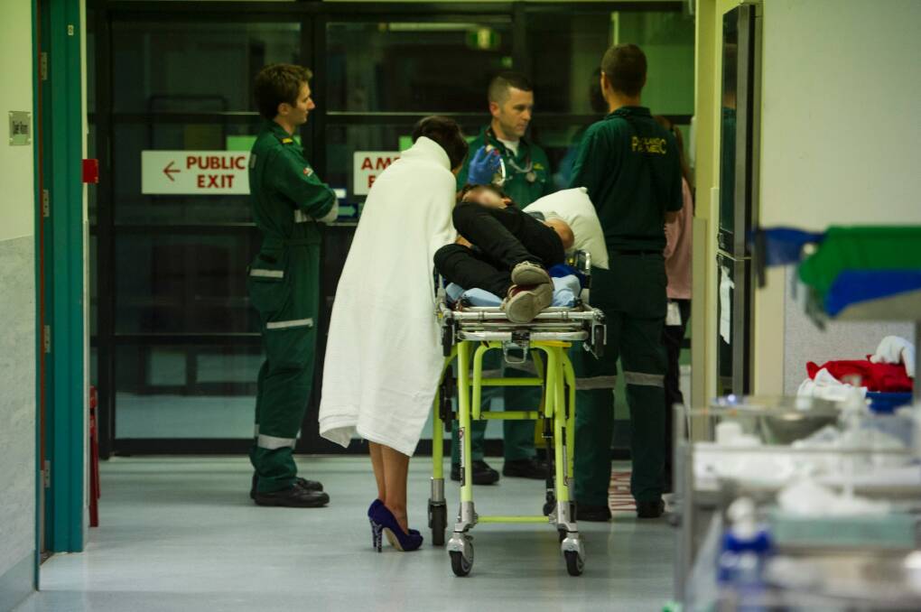 An intoxicated man arrives at the emergency department with his partner after collapsing at Mooseheads night club. Photo: Jay Cronan