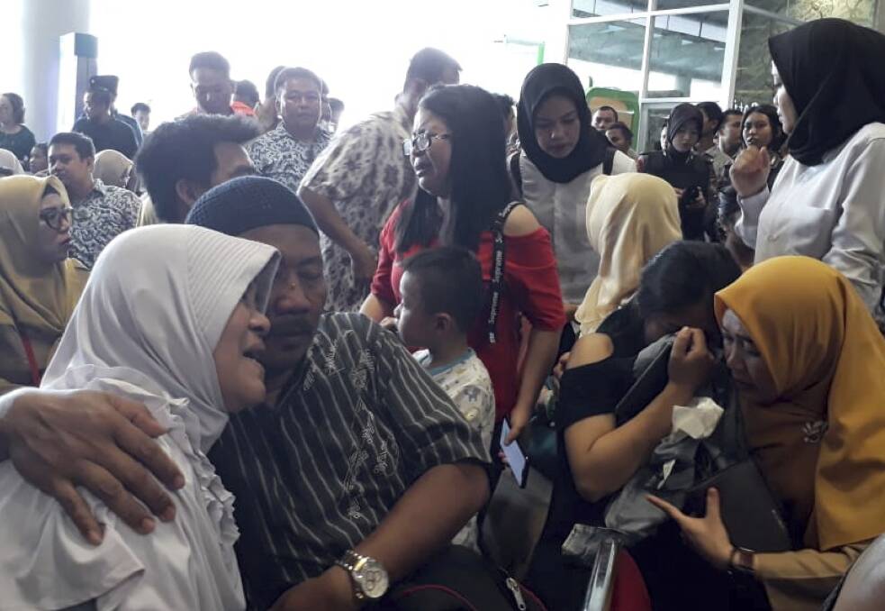 Relatives of passengers comfort each other at Depati Amir Airport in Pangkal Pinang as they wait for news on a Lion Air plane that crashed off Java Island. Photo: AP