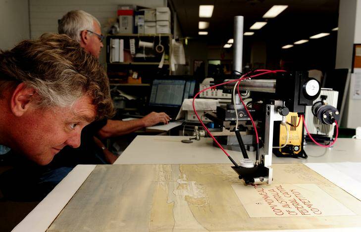 Assistant driector preservation at the National Archives, Ian Batterham with original entries of Burley Griffin's Canberra Design entries. Photo: Melissa Adams
