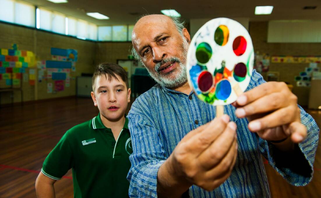 Indian toy maker and science educator Arvind Gupta, visits Charnwood-Dunlop Primary School with year 6 student Marcus Andreatta 11, holding a mini-workshop showing toys made from trash. Photo: Elesa Kurtz